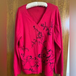 1X Red v neck sweater with black design.  Gently worn smoke free home .